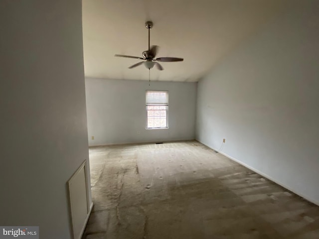 carpeted spare room with ceiling fan