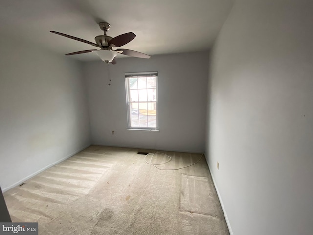 unfurnished room featuring light colored carpet and ceiling fan