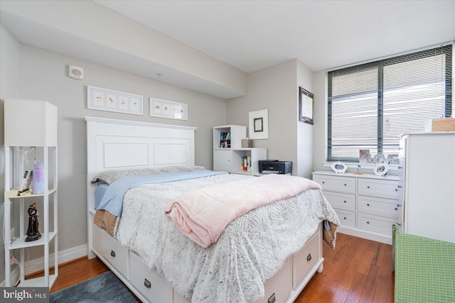 bedroom with dark hardwood / wood-style floors