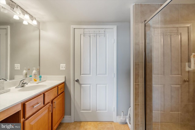 bathroom with vanity, an enclosed shower, and tile patterned flooring