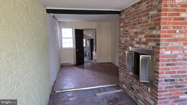 unfurnished living room featuring hardwood / wood-style flooring and a brick fireplace