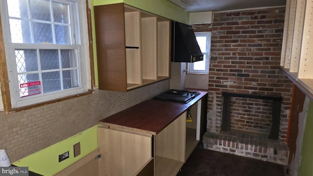 kitchen featuring backsplash, extractor fan, and gas cooktop