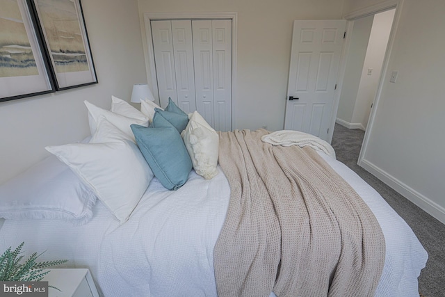 bedroom with baseboards, a closet, and carpet floors