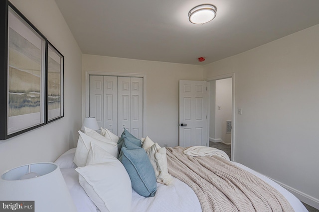 bedroom with a closet, visible vents, and baseboards