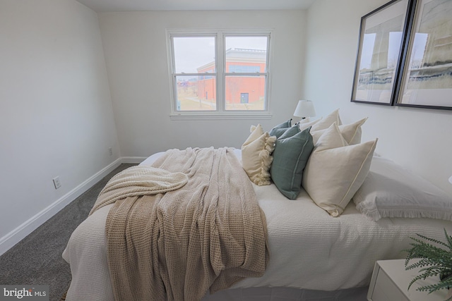 bedroom with baseboards and carpet