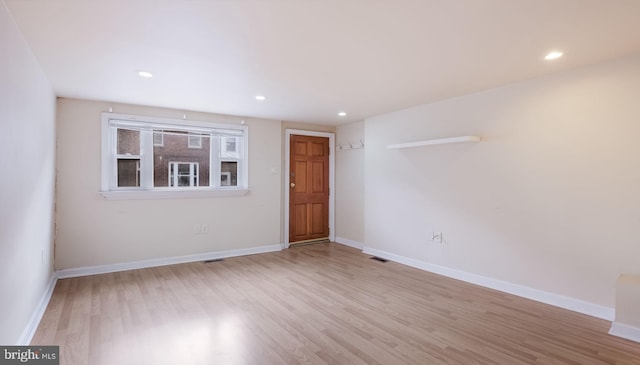 empty room with light hardwood / wood-style floors