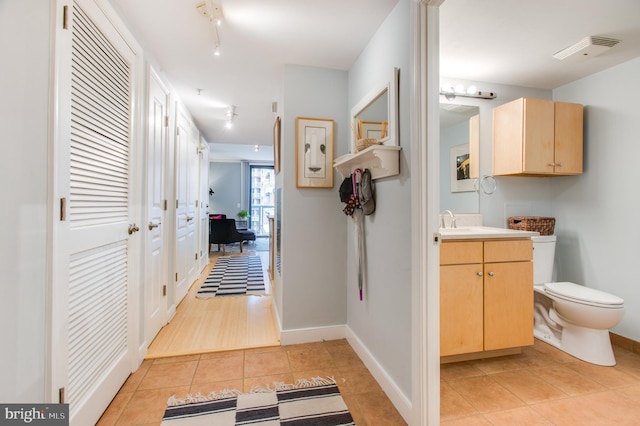 hall featuring light tile patterned flooring