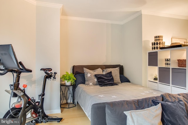 bedroom with light wood-type flooring and ornamental molding