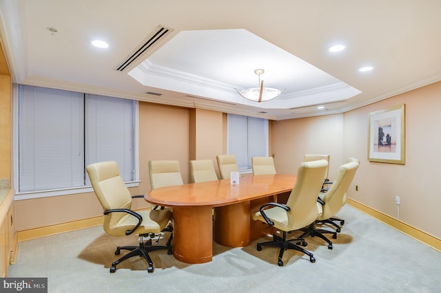 office featuring a tray ceiling, crown molding, and light carpet