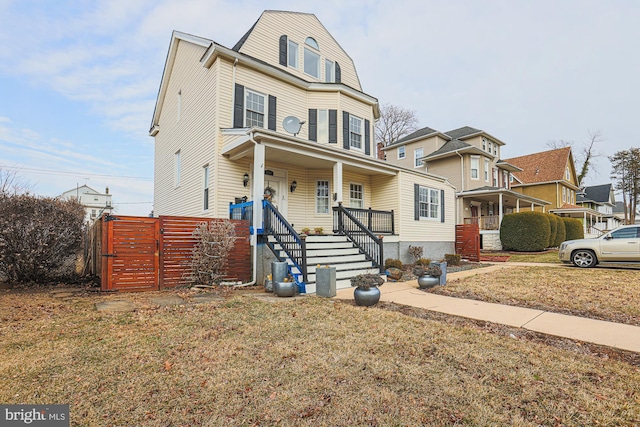 view of front of home with covered porch and a front lawn