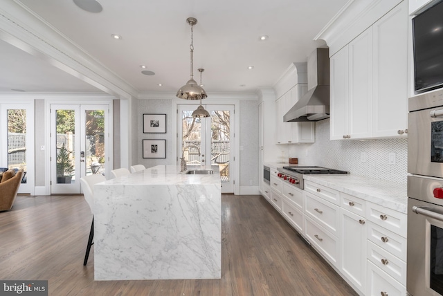 kitchen featuring ornamental molding, a sink, french doors, stainless steel gas stovetop, and wall chimney exhaust hood