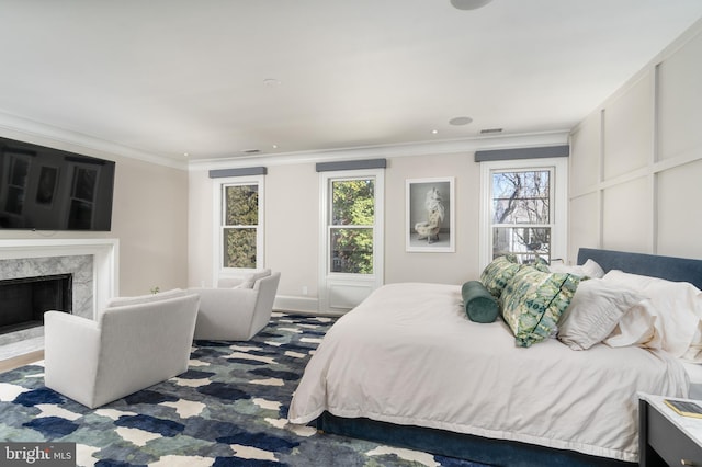 bedroom with visible vents, multiple windows, and crown molding