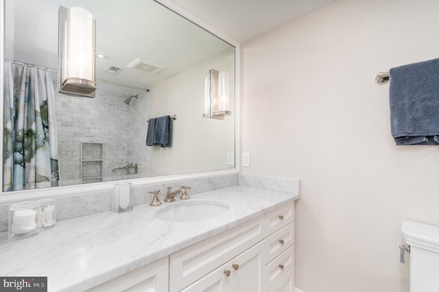 full bathroom featuring visible vents, vanity, toilet, and a shower