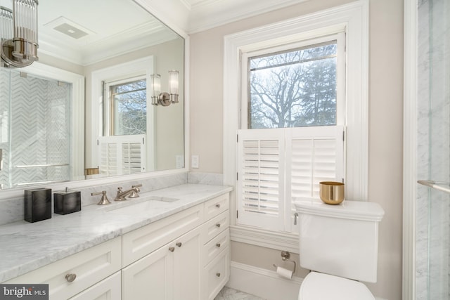 bathroom with plenty of natural light, toilet, vanity, and ornamental molding