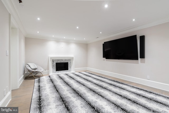 unfurnished living room with recessed lighting, crown molding, and light wood finished floors