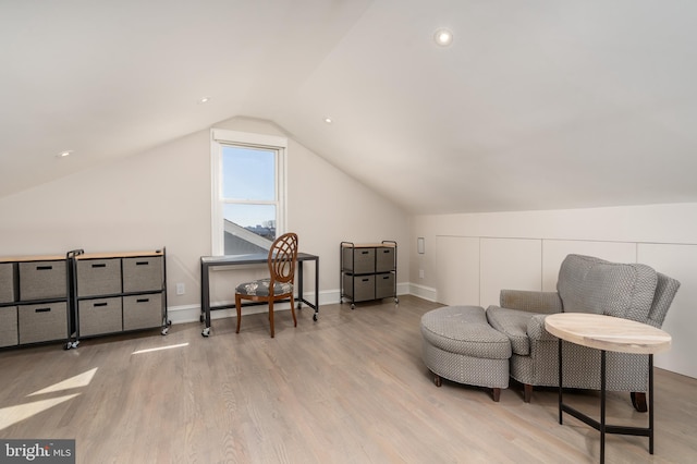 sitting room featuring lofted ceiling, wood finished floors, and baseboards