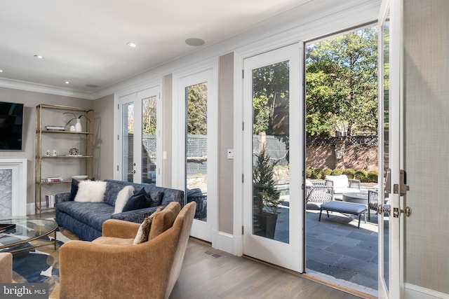 entryway with wood finished floors, visible vents, recessed lighting, ornamental molding, and french doors