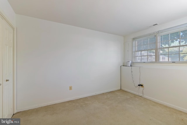 empty room featuring light carpet