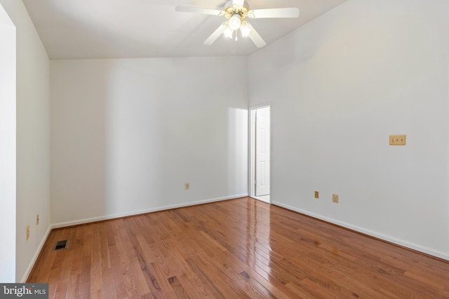 empty room with ceiling fan and hardwood / wood-style floors