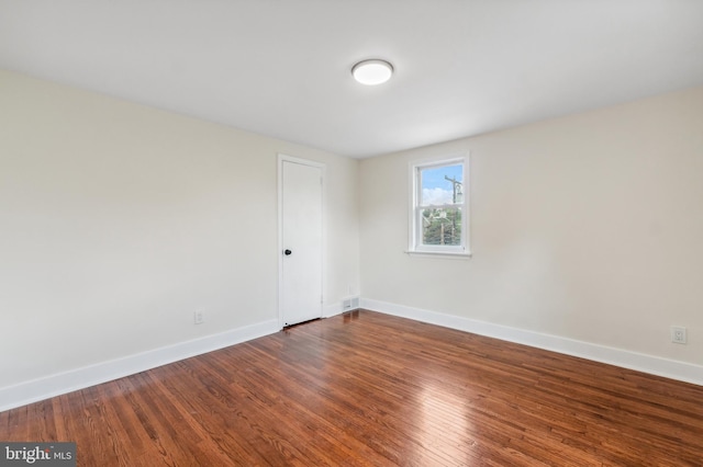 empty room with dark wood-type flooring