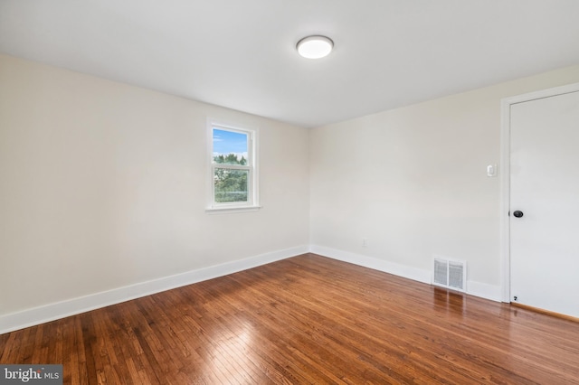 spare room with wood-type flooring