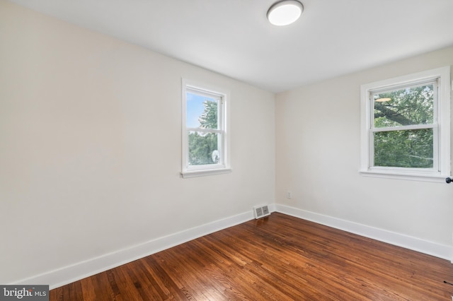 spare room with wood-type flooring