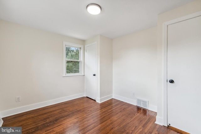 empty room featuring dark hardwood / wood-style floors