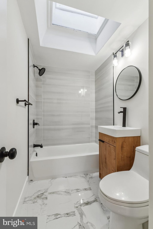 full bathroom featuring washtub / shower combination, vanity, a skylight, and toilet