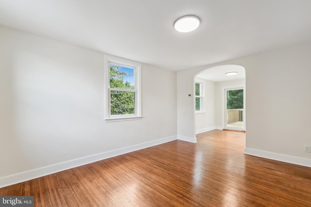 empty room featuring hardwood / wood-style flooring and a healthy amount of sunlight