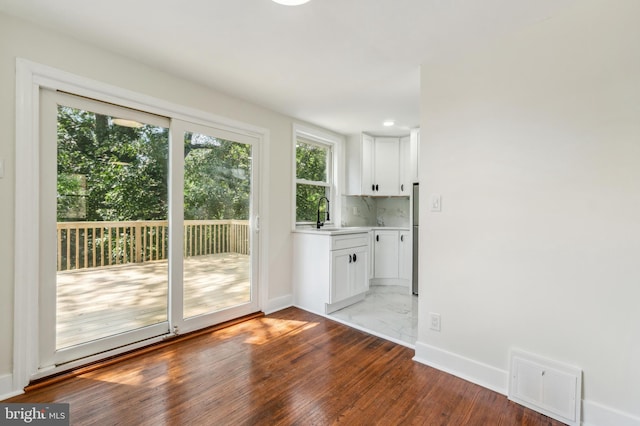 doorway to outside featuring light hardwood / wood-style floors and sink