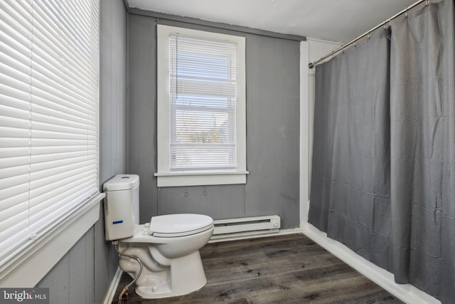 bathroom featuring hardwood / wood-style floors, a baseboard radiator, toilet, and walk in shower