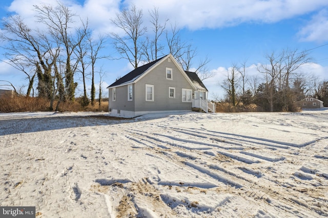 view of snow covered rear of property