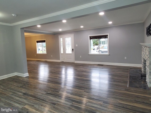 unfurnished living room with dark hardwood / wood-style flooring, a fireplace, and ornamental molding