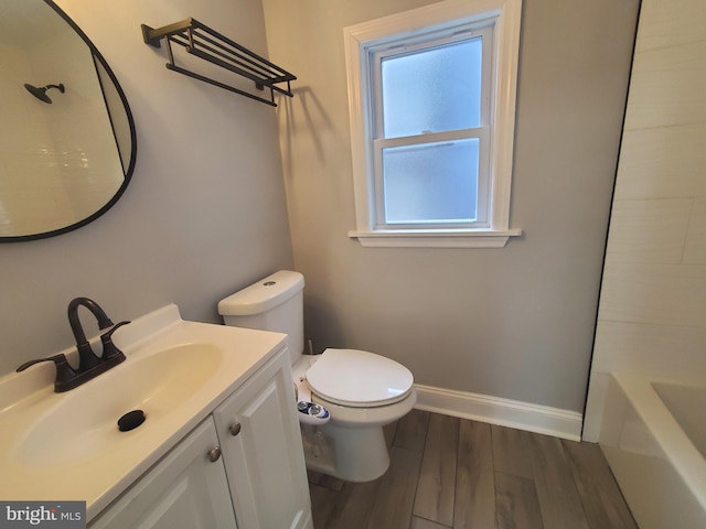 bathroom featuring vanity, toilet, and hardwood / wood-style floors