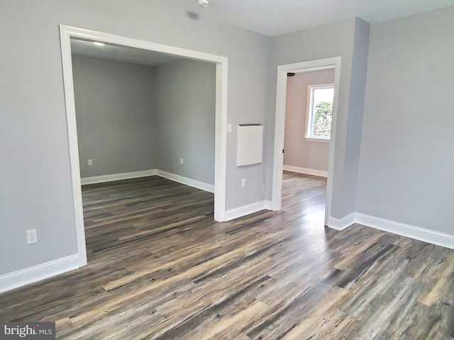 spare room featuring dark hardwood / wood-style floors