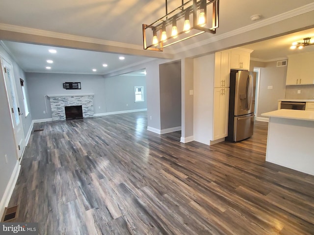 unfurnished living room with crown molding, a fireplace, and dark hardwood / wood-style flooring