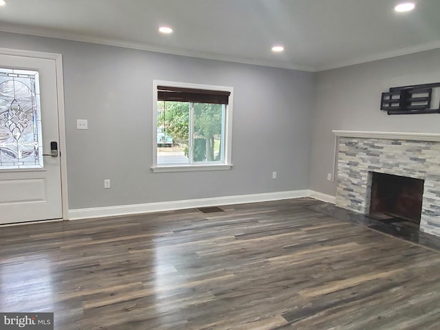 unfurnished living room with ornamental molding, dark hardwood / wood-style floors, and a fireplace