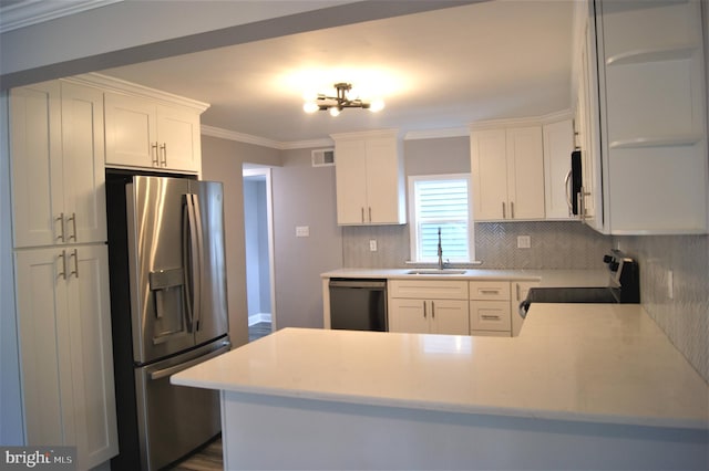 kitchen with sink, white cabinetry, ornamental molding, stainless steel appliances, and decorative backsplash