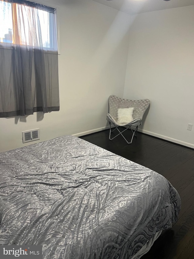 bedroom with hardwood / wood-style floors