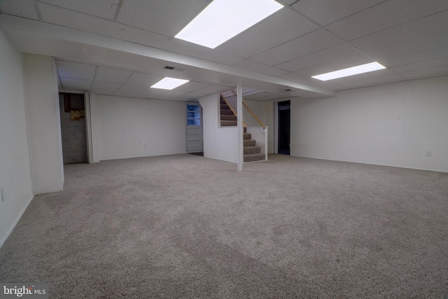 basement with carpet flooring and a paneled ceiling