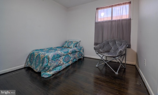 bedroom with dark wood-type flooring