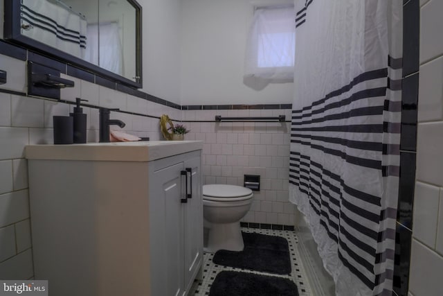 bathroom featuring toilet, tile walls, a shower with curtain, and tile patterned flooring