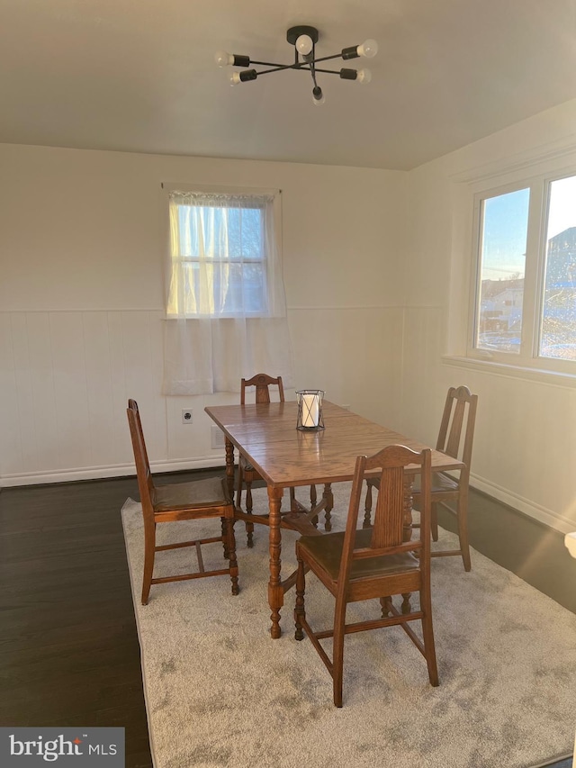 dining room featuring dark hardwood / wood-style flooring and an inviting chandelier