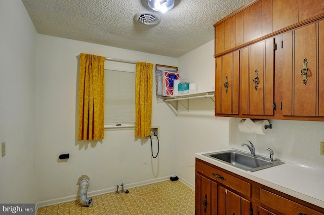 washroom featuring cabinets, hookup for a gas dryer, sink, washer hookup, and a textured ceiling