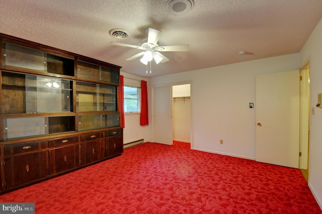 unfurnished living room featuring carpet flooring, a textured ceiling, baseboard heating, and ceiling fan