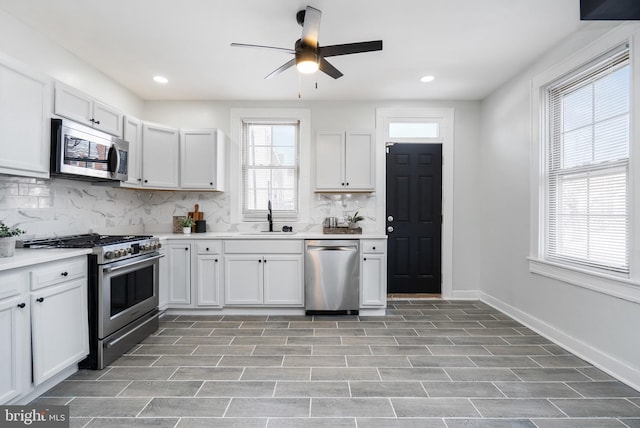 kitchen featuring decorative backsplash, stainless steel appliances, and white cabinetry