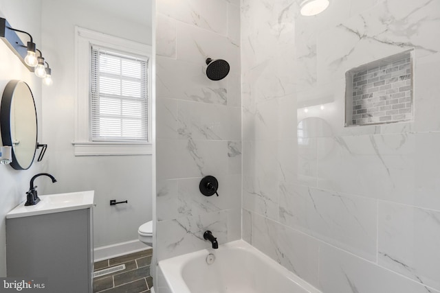 full bathroom featuring vanity, toilet, and tiled shower / bath