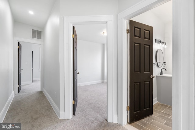 corridor with light colored carpet