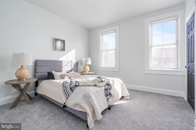 carpeted bedroom with multiple windows and lofted ceiling