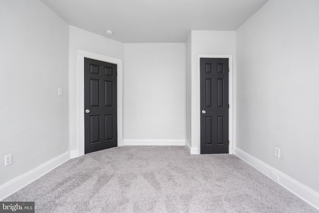 unfurnished room with light carpet